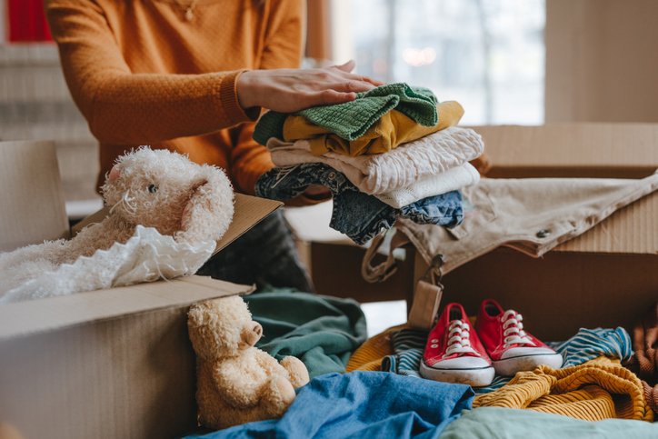 A woman sorting her belongings to keep or donate after listing a home in Albuquerque.